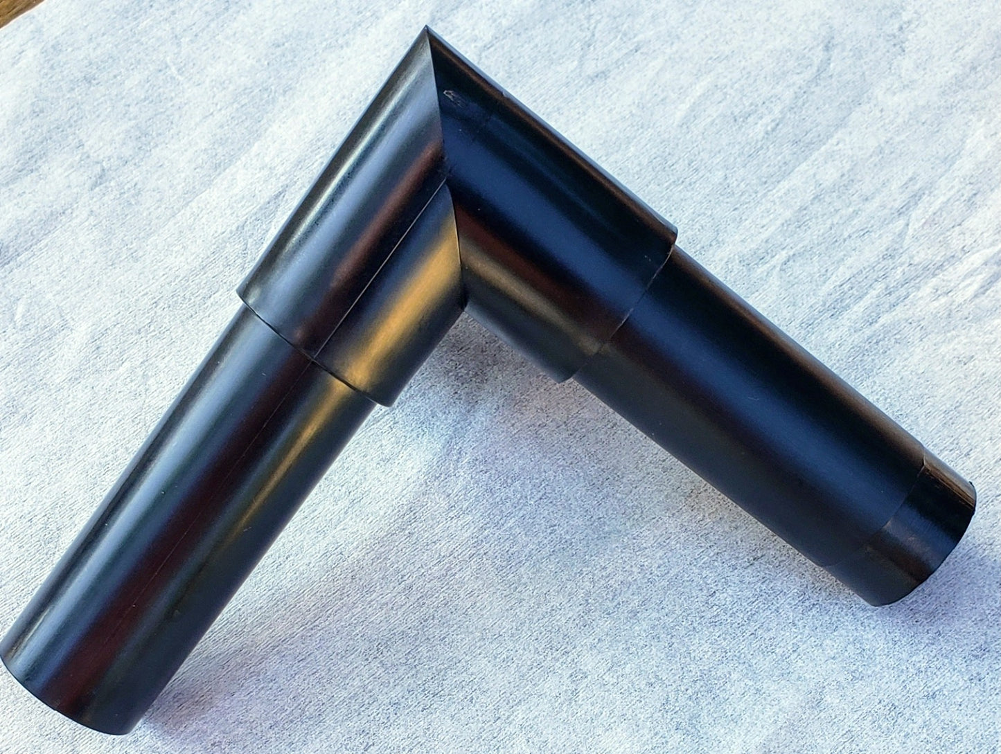 Top view of Alpha Edge 90° Corner Connector showing interior and exterior design for professional landscape edging right-angle corners