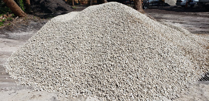 Bulk pile of #57 Limestone gravel for landscaping, driveways, and construction projects, clean and high-quality aggregate from Florida supplier.