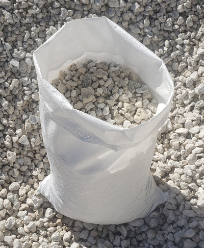 Bag of #57 Limestone gravel weighing 40–45 pounds, clean and high-quality aggregate for landscaping, driveways, and construction projects.