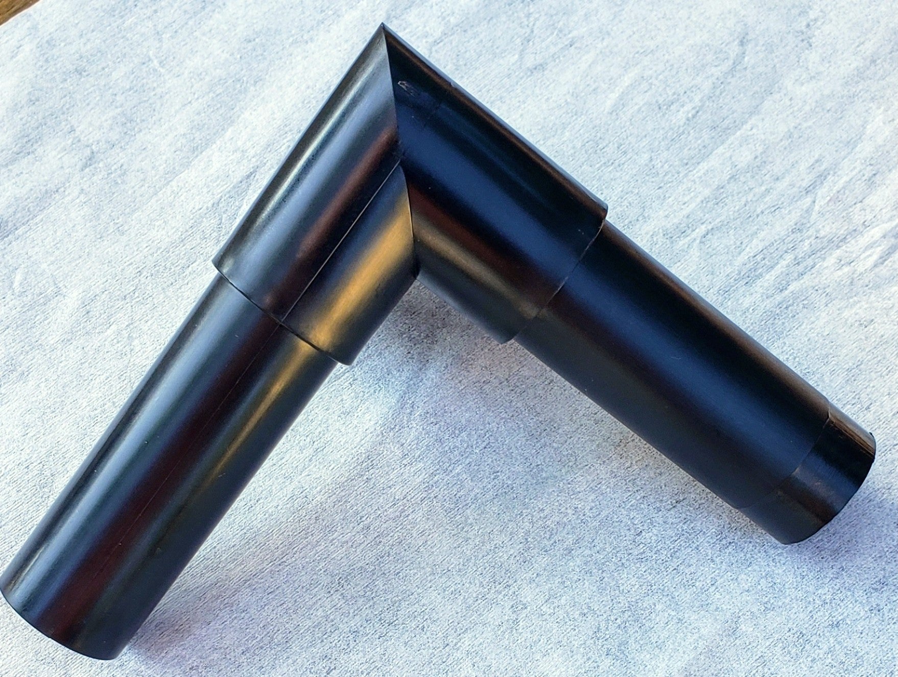 Top view of Alpha Edge 90° Corner Connector showing interior and exterior design for professional landscape edging right-angle corners