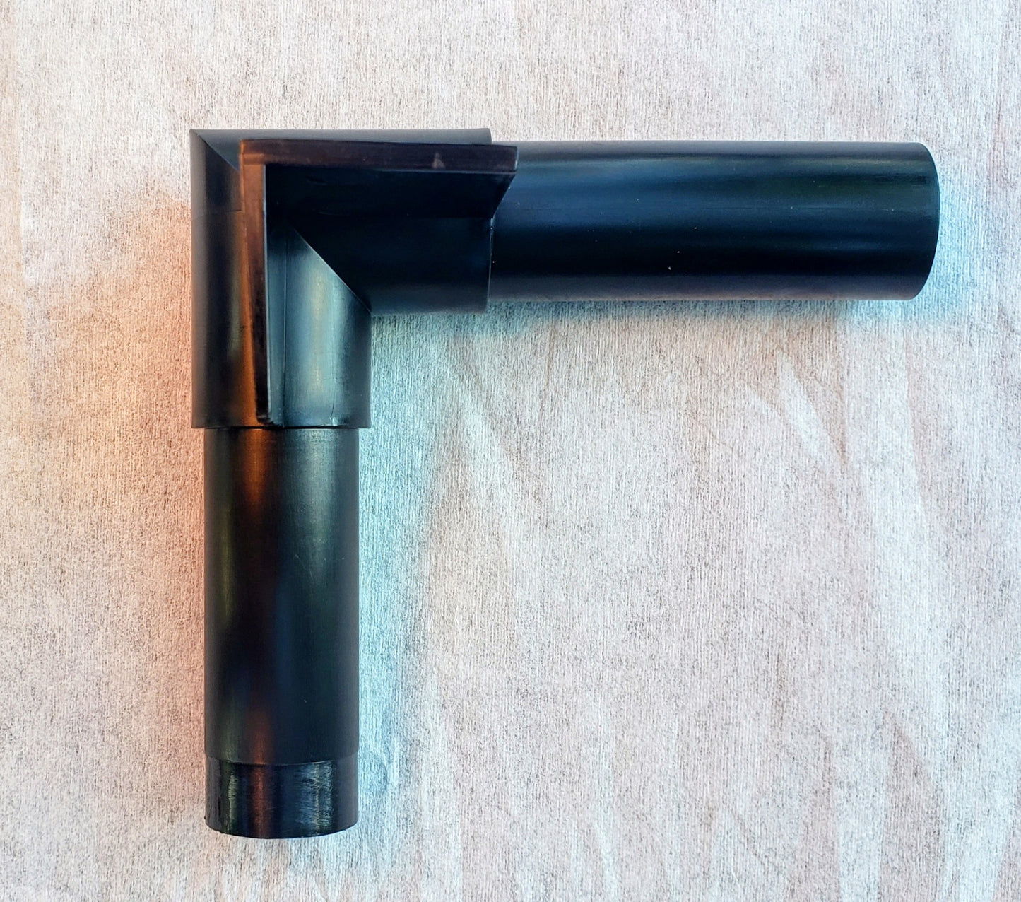 Top view of Alpha Edge 90° Corner Connector for landscape edging showing shape and design for professional right-angle installation