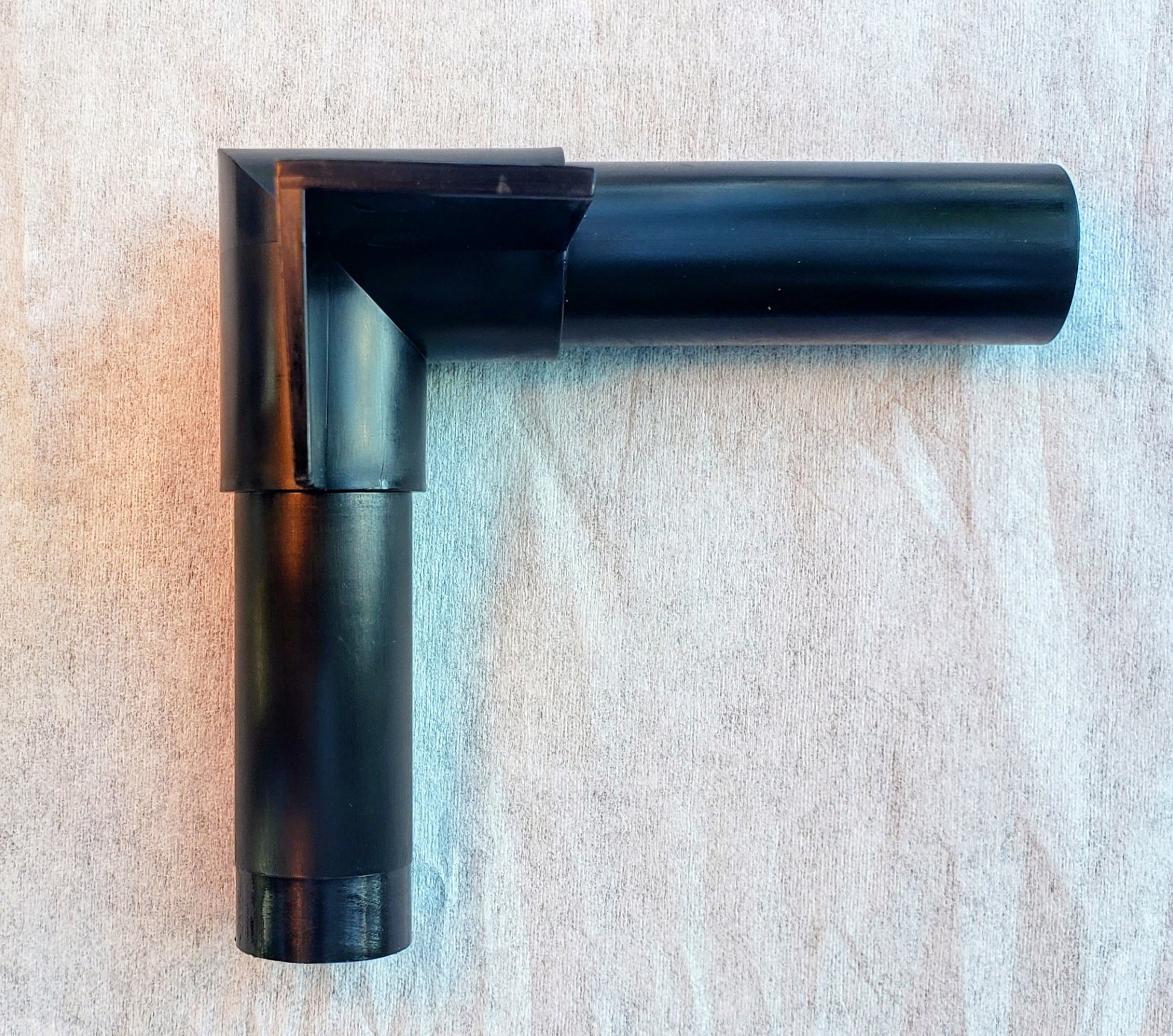 Top view of Alpha Edge 90° Corner Connector for landscape edging showing shape and design for professional right-angle installation