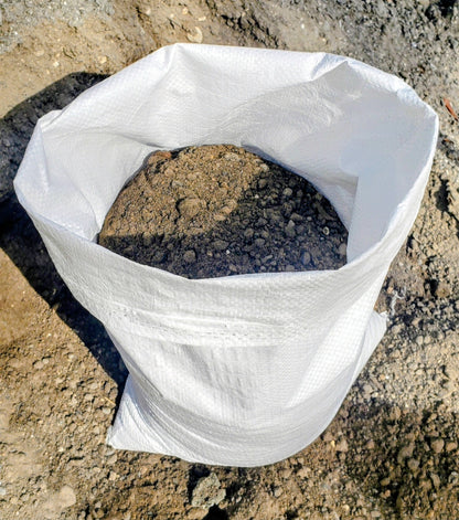 Bag of Paver Base Type 2 Grade B containing finely ground recycled asphalt blend and crushed stone fines for small paver, walkway, and DIY hardscape projects.