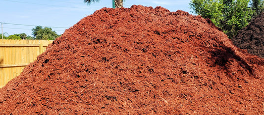 Bulk pile of Premium Red Mulch showing vibrant color and uniform texture for landscaping, gardens, flower beds, and pathways from Mulch and Stuff