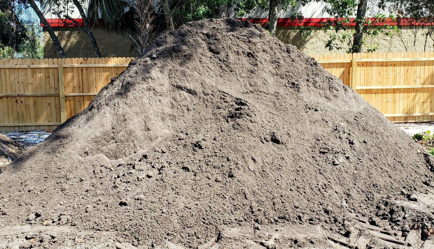 Bulk pile of premium top soil, clean and nutrient-rich, ready for landscaping, gardens, and lawn projects, Mulch and Stuff, Ormond Beach, FL