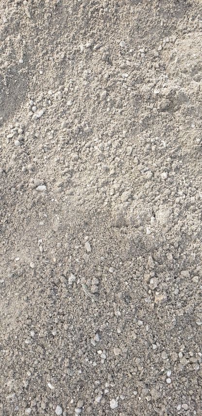 Close-up of Paver Base Type 2 Grade B showing crushed stone particles mixed with finely ground asphalt fines for superior compaction and drainage performance.