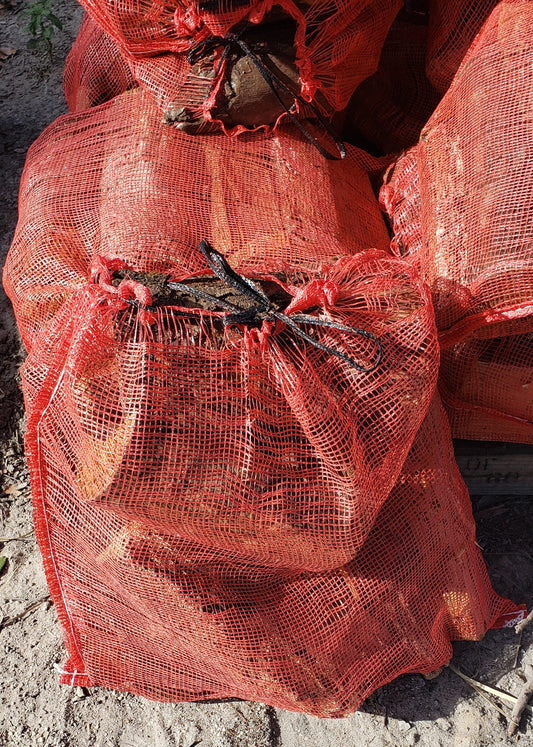 Close-up of premium seasoned firewood logs, clean-cut and ready for fireplaces, fire pits, and outdoor use from Mulch and Stuff in Ormond Beach