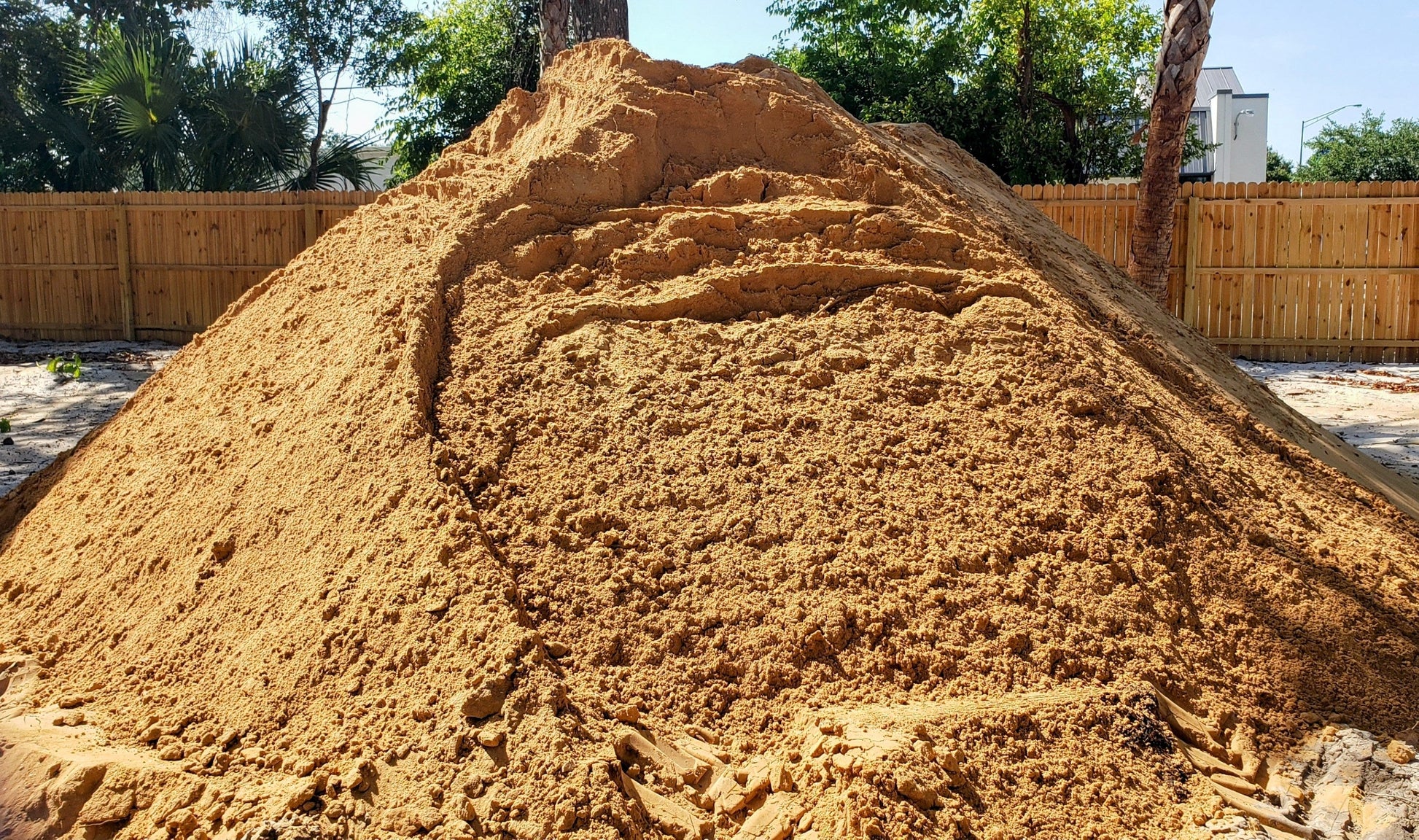Bulk pile of premium red sand for landscaping and paver base, clean and fine, from Mulch and Stuff, Ormond Beach, FL