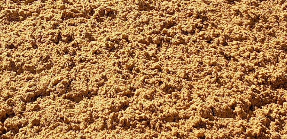 Close-up of premium red sand showing fine texture and quality for landscaping and paver base by Mulch and Stuff